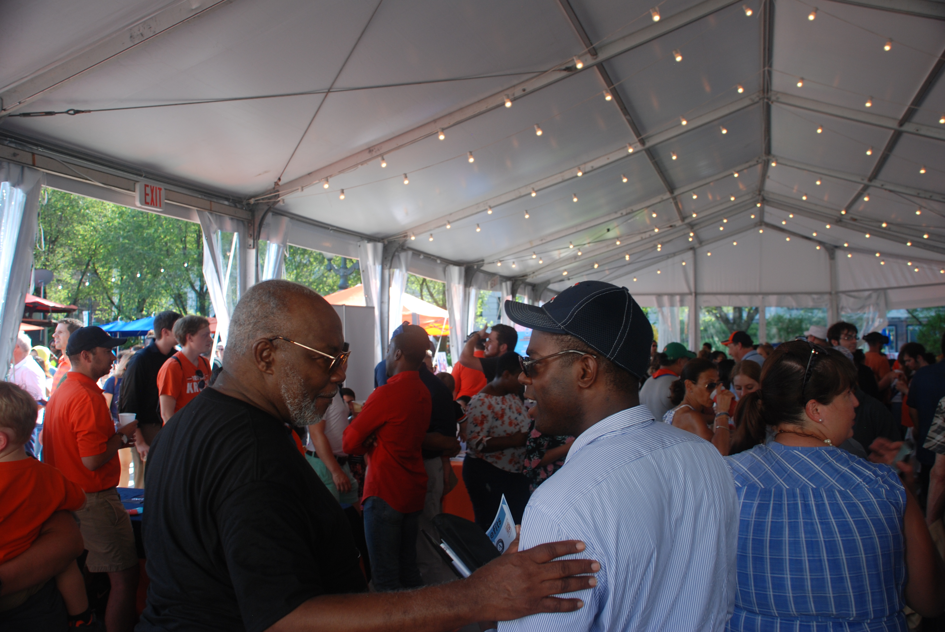 Illini Fest crowd with Dr. Bailey speaking with a visiting colleague in the foreground.