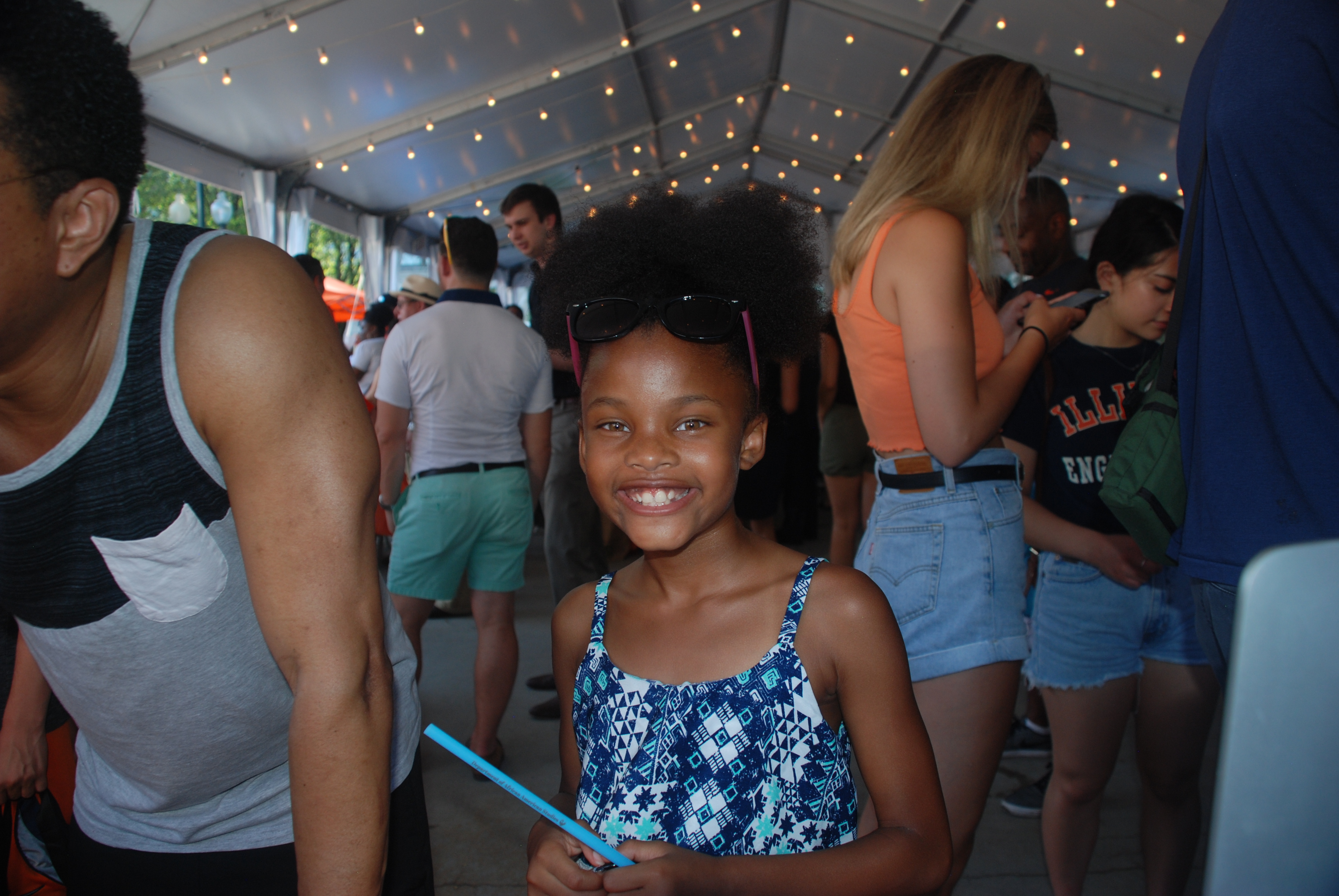 Young girl smiling at the AFRO table as she tells us about her hopes to be a scientist or a performing artist