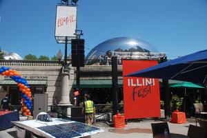 Chicago Cloud Gate sculpture (AKA The Bean) with Illini Fest event signs in the foreground